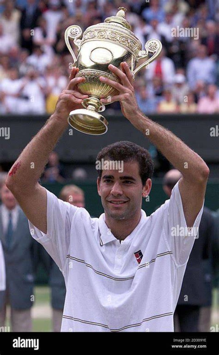 Sampras lifts the trophy and gains his seventh Wimbledon title.
